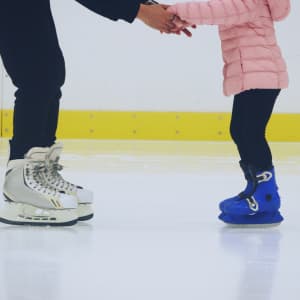 Picture an adult helping a child to learn to skate