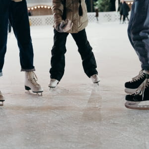 picture of 2 adults and child ice skating 