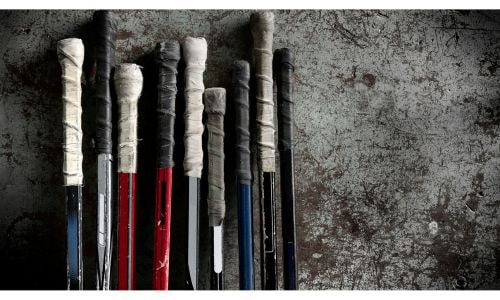 Hockey sticks with black and white grip tape