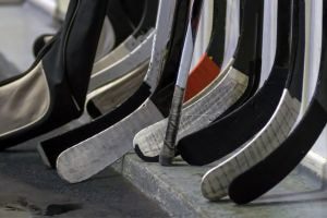 Group of hockey sticks with black and white tape