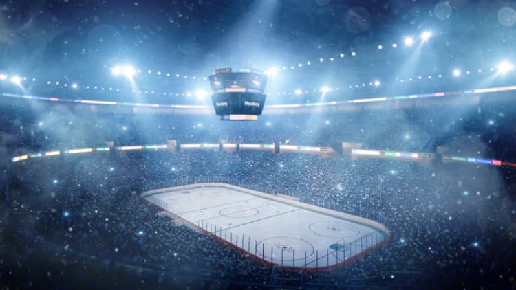 NHL professional ice hockey arena with clock hanging in the middle for spectators