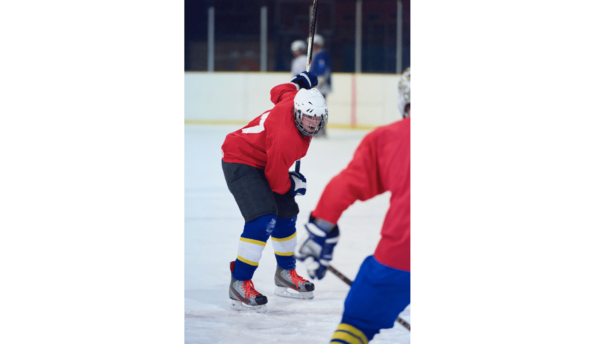 3.teen ice hockey player making a pass