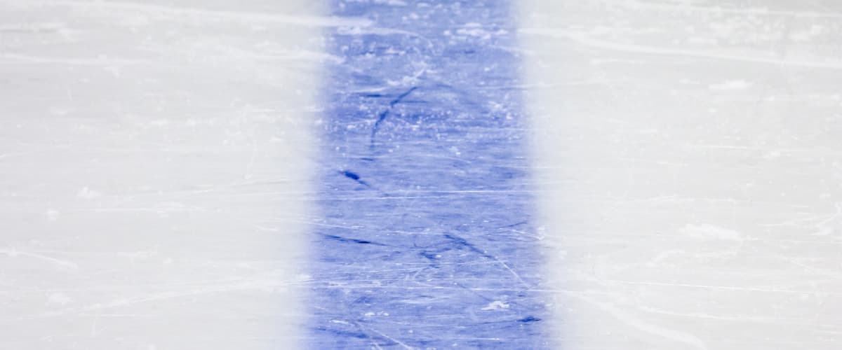 Zoomed picture of blue lin on ice hockey rink