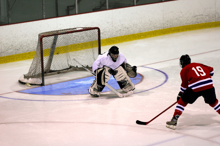 Sniper on the offense taking a shot with goalie in front of the net