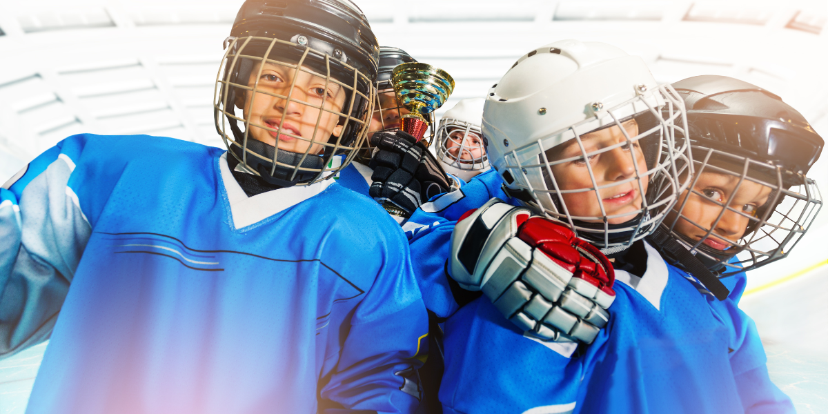 Group of boys smiling playing ice hockey