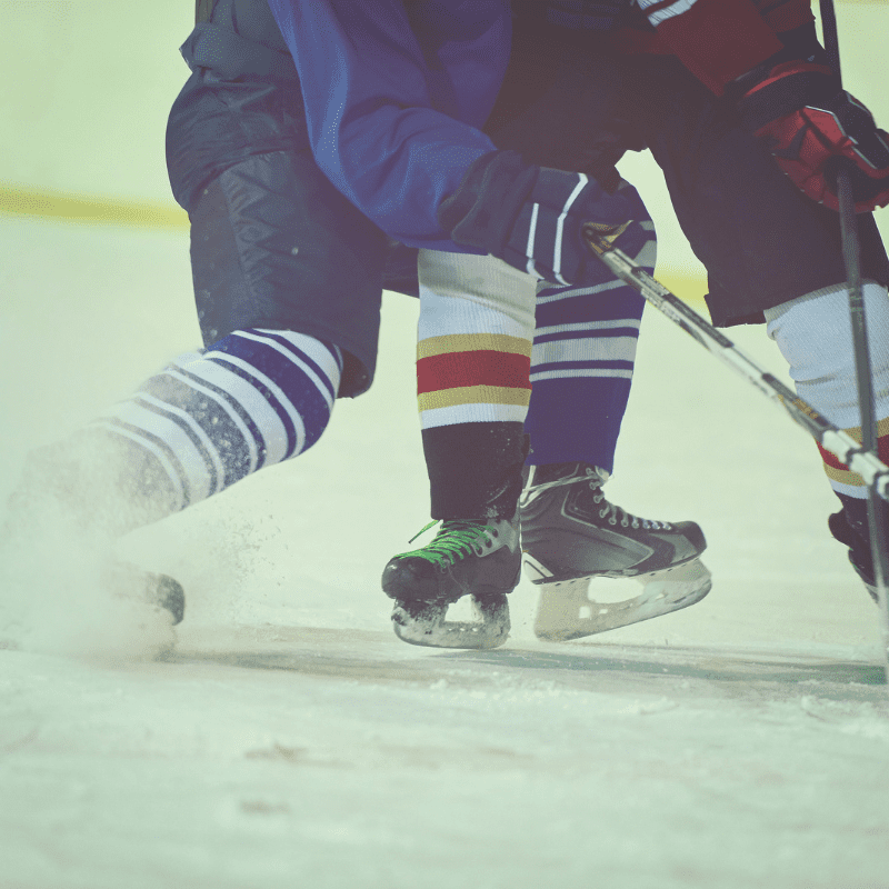 hip body check showing only bottom part of two ice hockey players