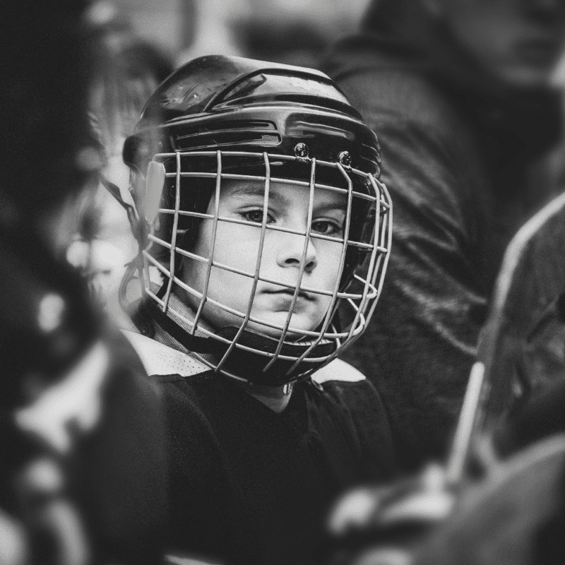 Young ice hockey player in black and white picture with helmet