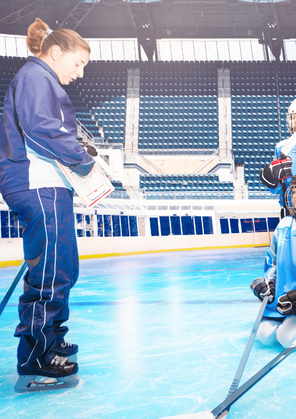 Hockey Coach explaining a play on white board to youth hockey players