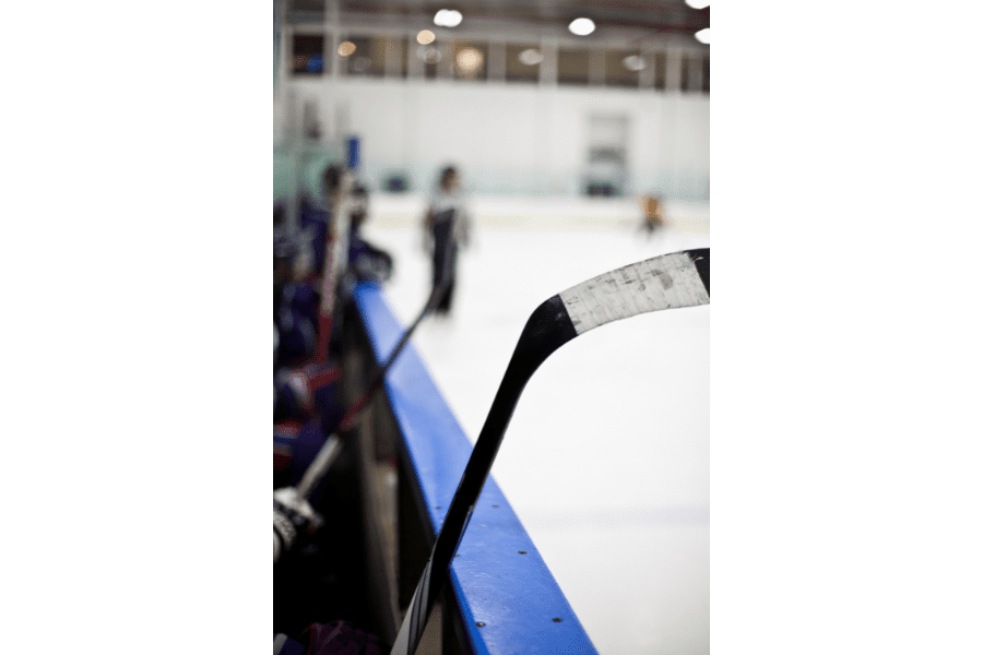 picture of hockey sticks held by ice hokcey players ready to take the ice 