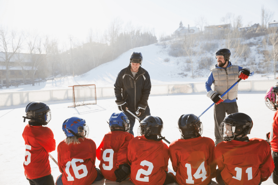 coaches on outside ice with youth ice hockey