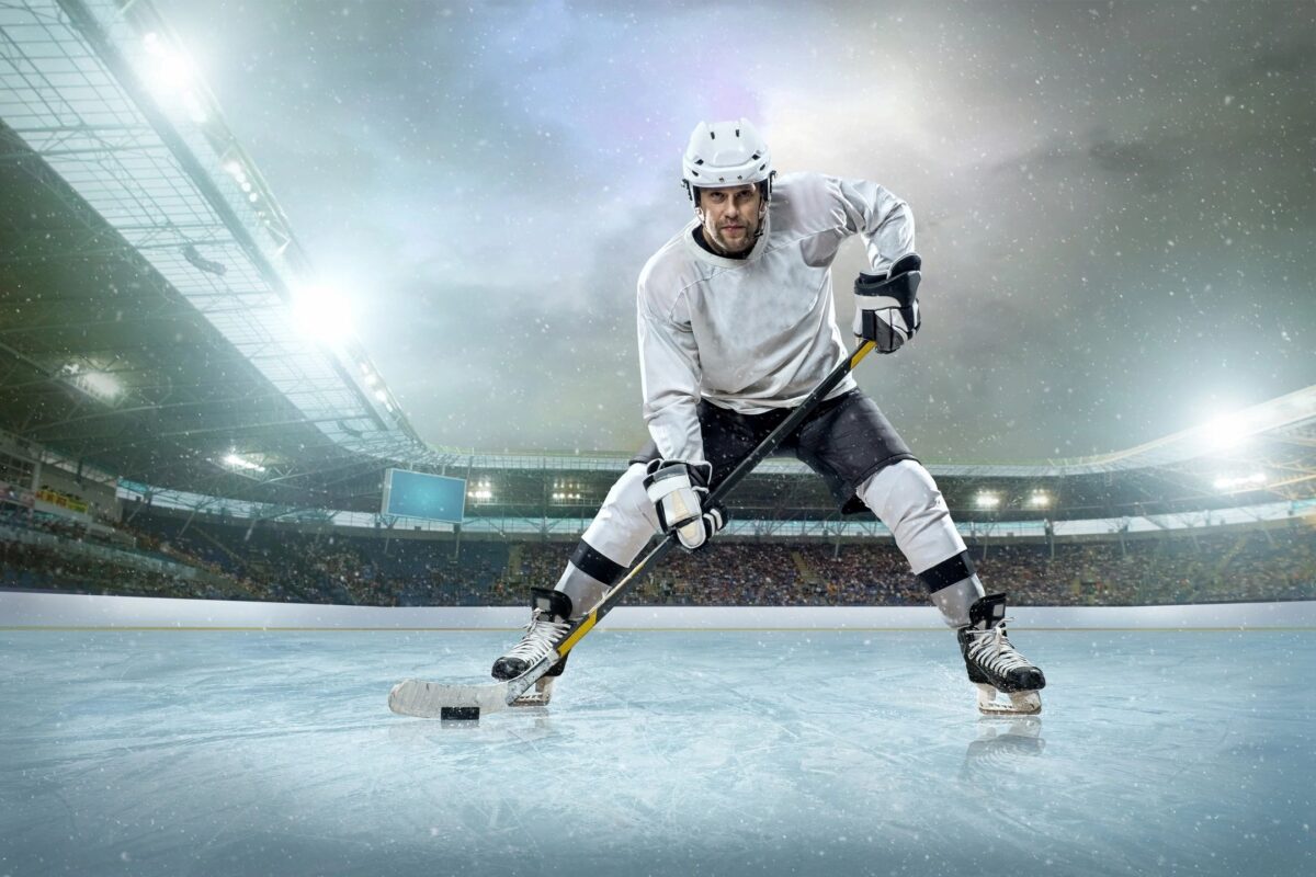 Hockey player with ice hockey stick and puck