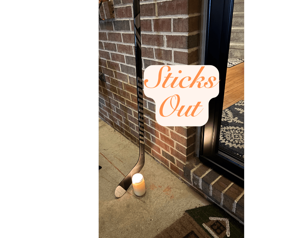 Candle and Ice Hockey Stick on Porch with text: Sticks Out